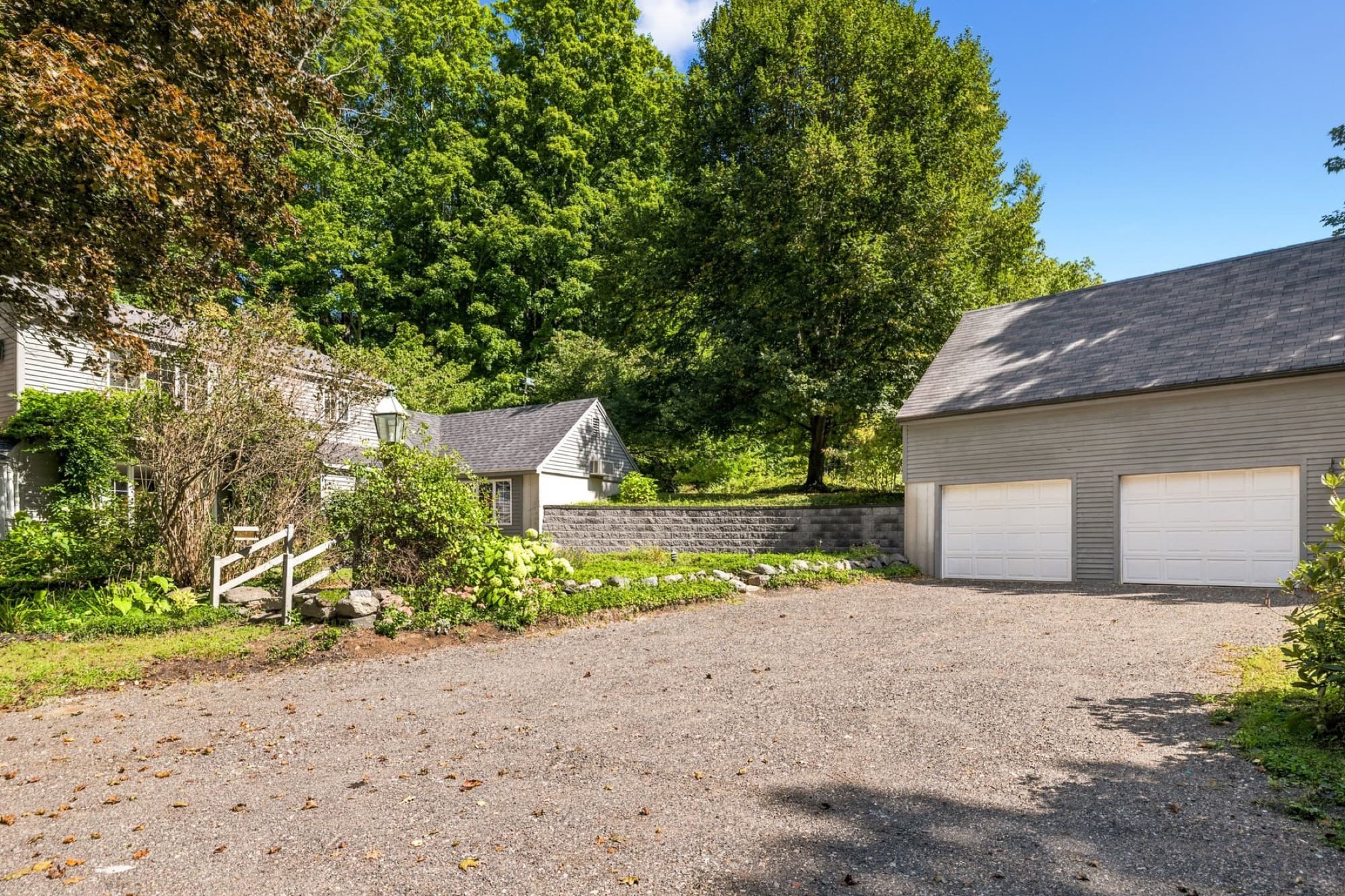 The detached 2-car garage and the stone retaining wall from the driveway