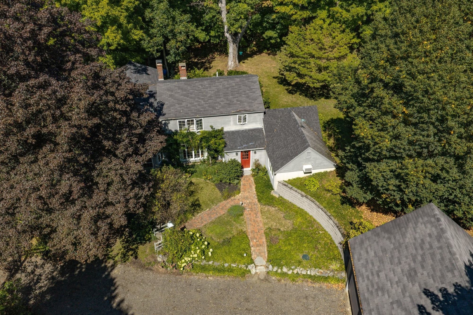 The house from the air, with the brick walk, the gardens, and the garage